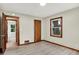This bedroom has a light colored floor, an entry doorway and a wooden door at 840 N Indiana St, Mooresville, IN 46158