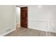 This bedroom features white shiplap, a wooden door, and a view of another room at 840 N Indiana St, Mooresville, IN 46158