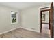 Bright bedroom featuring light wood flooring and a window with natural light at 840 N Indiana St, Mooresville, IN 46158
