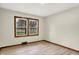 This bedroom features a light colored floor and two windows with wooden trim at 840 N Indiana St, Mooresville, IN 46158
