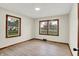 This bedroom features a light colored floor and two windows with wooden trim at 840 N Indiana St, Mooresville, IN 46158
