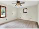 Spacious bedroom with wood-look floors, two windows, and neutral walls at 840 N Indiana St, Mooresville, IN 46158