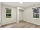 This bedroom features a light colored floor and two windows with a closet space in the center at 840 N Indiana St, Mooresville, IN 46158
