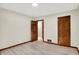 This bedroom has a light colored floor, an entry doorway and a wooden door at 840 N Indiana St, Mooresville, IN 46158
