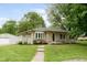 Charming single-story home featuring a stone facade, manicured lawn, and a walkway to the front entrance at 840 N Indiana St, Mooresville, IN 46158