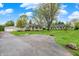 Charming stone home featuring a well-maintained lawn and mature shade trees at 840 N Indiana St, Mooresville, IN 46158