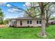 Charming stone home featuring a well-maintained lawn and mature shade trees at 840 N Indiana St, Mooresville, IN 46158