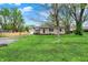 Charming stone home featuring a well-maintained lawn and mature shade trees at 840 N Indiana St, Mooresville, IN 46158