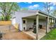 A detached garage with white door featuring an enclosed area with a carport for storage and parking at 840 N Indiana St, Mooresville, IN 46158