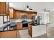 Well-lit kitchen featuring stainless appliances, dark countertops and wood cabinets at 840 N Indiana St, Mooresville, IN 46158