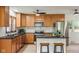 Kitchen with wooden cabinets, a stainless steel refrigerator, and a center island with bar stool seating at 840 N Indiana St, Mooresville, IN 46158