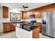 Updated kitchen showcasing stainless steel appliances, wood cabinetry, and modern finishes at 840 N Indiana St, Mooresville, IN 46158