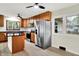 Modern kitchen featuring stainless steel appliances, wood cabinets, and a dark island countertop at 840 N Indiana St, Mooresville, IN 46158