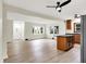 Spacious living area featuring hardwood floors, updated fixtures, and a view into the kitchen at 840 N Indiana St, Mooresville, IN 46158