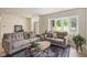 Bright living room with neutral-toned furniture, a bay window, and stylish decor on a patterned rug at 840 N Indiana St, Mooresville, IN 46158
