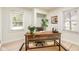 Comfortable home office featuring rustic wooden desk, neutral walls, and lots of natural light at 840 N Indiana St, Mooresville, IN 46158