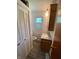 A half bathroom with a wood cabinet and a toilet next to a closet at 89 Judy Dr, Martinsville, IN 46151