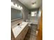 Bathroom featuring vanity with stone top, tub with tile surround and vinyl floor at 89 Judy Dr, Martinsville, IN 46151