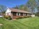 Well-maintained brick home with green lawn and manicured shrubbery at 89 Judy Dr, Martinsville, IN 46151