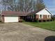 Charming single story brick home with manicured lawn, two car garage and concrete driveway at 89 Judy Dr, Martinsville, IN 46151