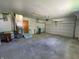 Interior view of a garage featuring painted concrete floor and stairs at 89 Judy Dr, Martinsville, IN 46151