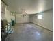 Garage interior featuring a utility hookup, stairs, and garage door at 89 Judy Dr, Martinsville, IN 46151