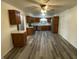 Well-lit kitchen boasts wooden cabinets, stainless steel appliances, and modern grey laminate flooring at 89 Judy Dr, Martinsville, IN 46151