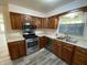 Charming kitchen showcases stainless appliances, wood cabinets, and bright lighting at 89 Judy Dr, Martinsville, IN 46151