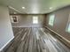 Large living room with recessed lighting, fresh paint, and stylish new flooring at 89 Judy Dr, Martinsville, IN 46151