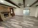 Spacious living room features a stone fireplace, beamed ceilings, and new flooring at 89 Judy Dr, Martinsville, IN 46151