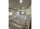 Large living room with recessed lighting, fresh paint, and stylish new flooring at 89 Judy Dr, Martinsville, IN 46151