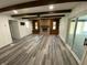 Spacious living room features a stone fireplace, beamed ceilings, and new flooring at 89 Judy Dr, Martinsville, IN 46151