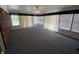 Spacious living room with neutral carpet, multiple windows and ceiling fan at 89 Judy Dr, Martinsville, IN 46151