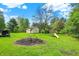 Sprawling backyard with a detached garage and playground set, ideal for outdoor activities at 8906 N County Road 1050 E, Brownsburg, IN 46112