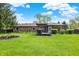 Lovely brick home with a spacious lawn, wooden deck, and bright sunroom at 8906 N County Road 1050 E, Brownsburg, IN 46112
