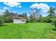 Large grassy backyard featuring a detached garage, play set, and plenty of space for recreation at 8906 N County Road 1050 E, Brownsburg, IN 46112