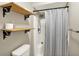 Bathroom with a shower featuring black metal shelving and a white and gray striped shower curtain at 8906 N County Road 1050 E, Brownsburg, IN 46112