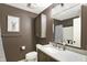 Well-lit bathroom features modern vanity, elegant mirror, and coordinated fixtures for a comfortable experience at 8906 N County Road 1050 E, Brownsburg, IN 46112