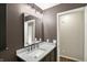 Modern bathroom featuring a gray vanity with white countertop and a large, well-lit mirror at 8906 N County Road 1050 E, Brownsburg, IN 46112