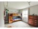Bright bedroom featuring a wooden bunkbed, playful wall art, and a classic wooden dresser at 8906 N County Road 1050 E, Brownsburg, IN 46112