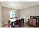 Bright dining room with a modern chandelier, dining table and chairs, and a view of the yard at 8906 N County Road 1050 E, Brownsburg, IN 46112