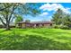 Charming brick home with a lush green lawn and mature trees in a residential neighborhood at 8906 N County Road 1050 E, Brownsburg, IN 46112
