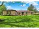 Charming brick ranch home boasts a well-manicured lawn, mature trees, and inviting curb appeal at 8906 N County Road 1050 E, Brownsburg, IN 46112