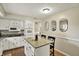 Bright kitchen features white cabinets, granite countertops, and a kitchen island for extra prep space at 8906 N County Road 1050 E, Brownsburg, IN 46112