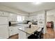 Bright kitchen features white cabinetry, granite countertops, stainless appliances, and a kitchen island with seating at 8906 N County Road 1050 E, Brownsburg, IN 46112