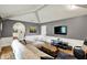 Spacious living room boasts comfortable sectional, hardwood floors, and a large TV for entertainment at 8906 N County Road 1050 E, Brownsburg, IN 46112