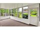 Bright sunroom features large windows offering views of the outdoors and brick accents at 8906 N County Road 1050 E, Brownsburg, IN 46112