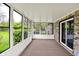 Inviting sunroom with black-framed windows and slider door opens to a backyard for outdoor enjoyment at 8906 N County Road 1050 E, Brownsburg, IN 46112