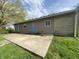 Backyard with concrete patio, grassy area and exterior of the home at 9048 E 36Th St, Indianapolis, IN 46235