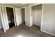 Bedroom featuring neutral walls, carpet flooring, and closet space; multiple entry points visible at 9048 E 36Th St, Indianapolis, IN 46235